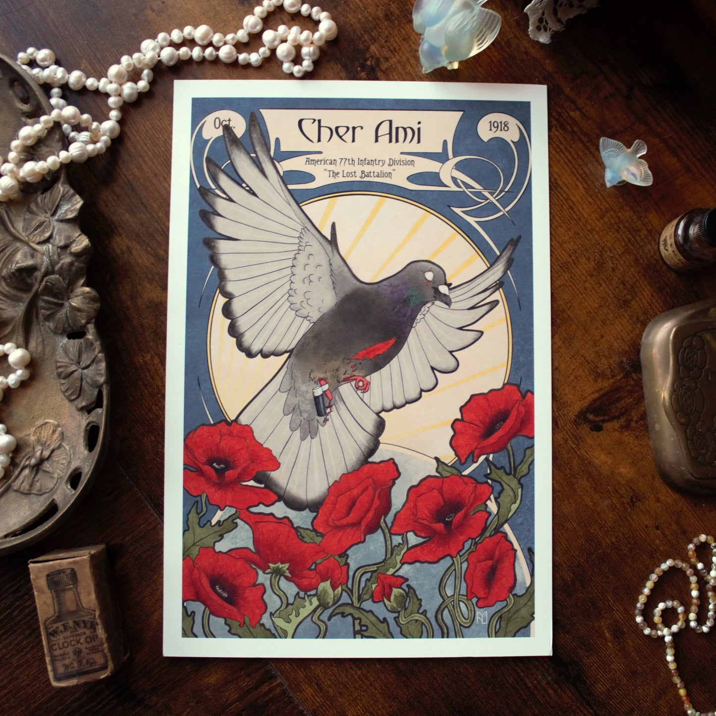 Poster of a pigeon and poppies with 'Cher Ami' text on a wooden surface with decorative items.