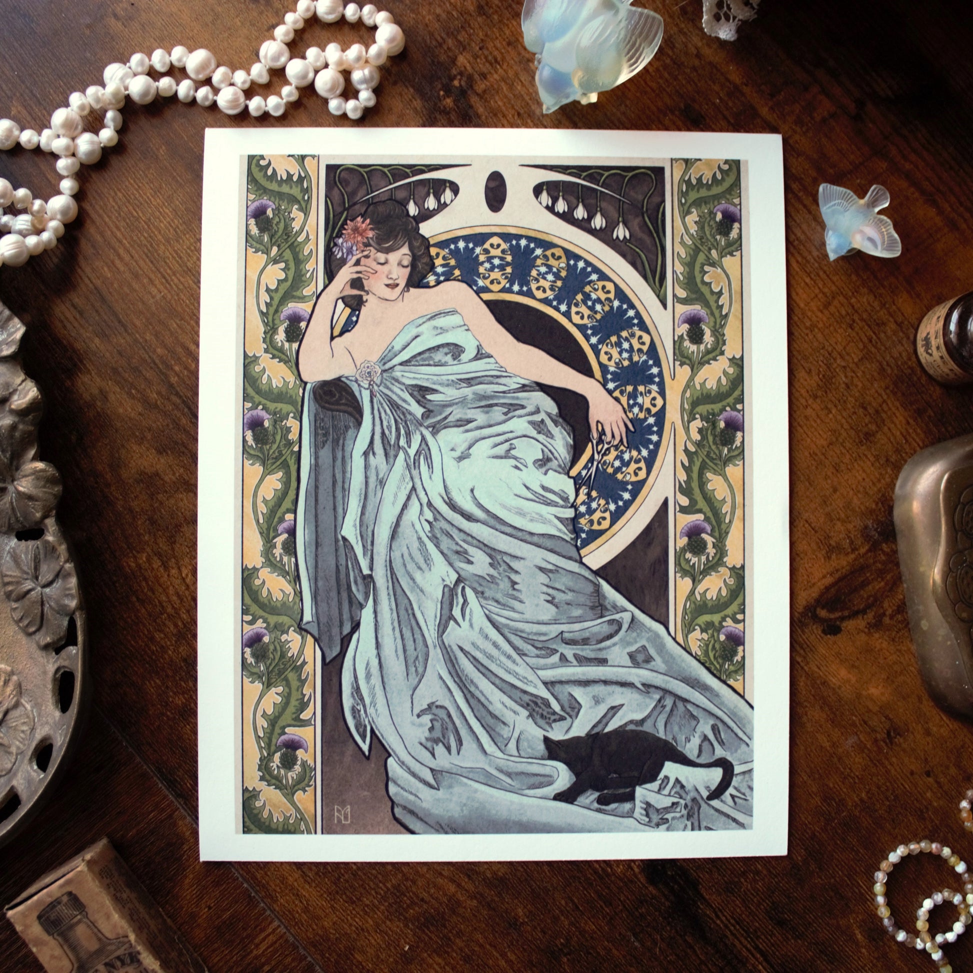 Art Nouveau-style illustration with a woman in a dress on a wooden surface with decorative items.